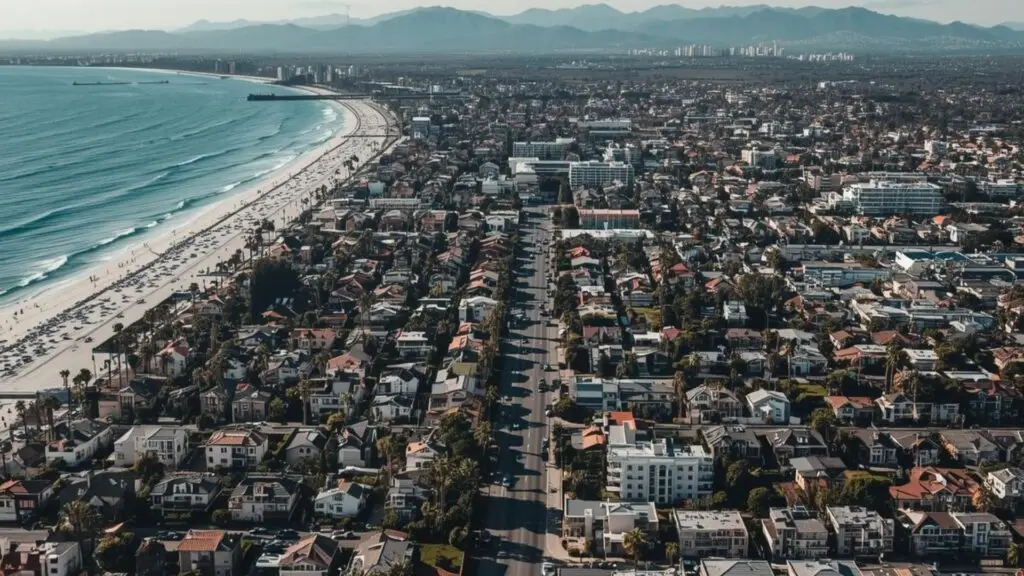 Coastal city with beach, houses, and streets, California real estate.