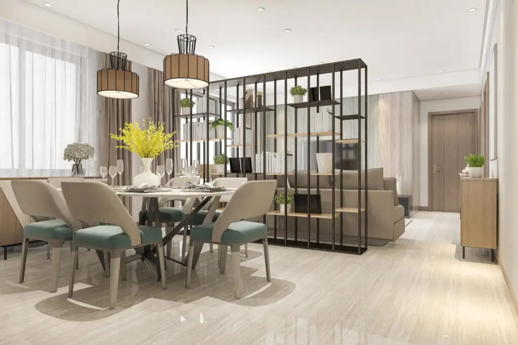 Dining area with table, chairs, and decorative plants.